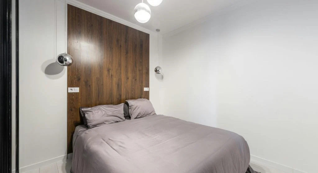 Small bedroom with light colored walls and minimal decor